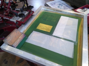Wax paper blocks out other stencils ganged onto screen.